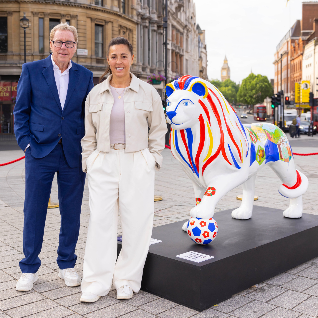 Harry Redknapp and Fara Williams MBE pose next to lion titled: Together We Roar Lion